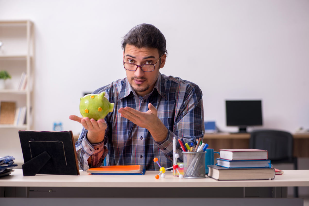 Young male student sitting in the classroom