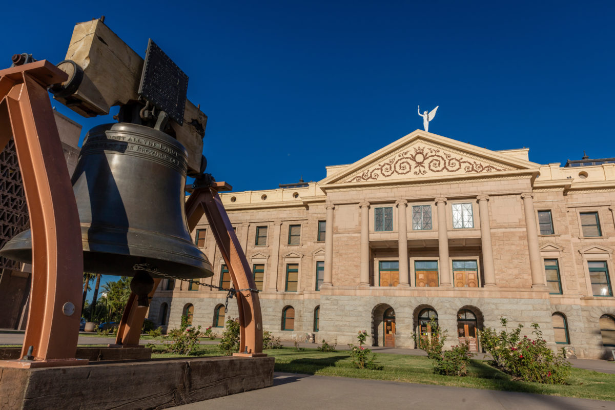 AUGUST 23, 2017 - PHOENIX ARIZONA - Replica of Liberty Bell in front of Arizona State Capitol Building at sunrise