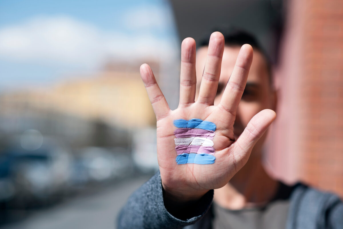 transgender flag in the palm of the hand.