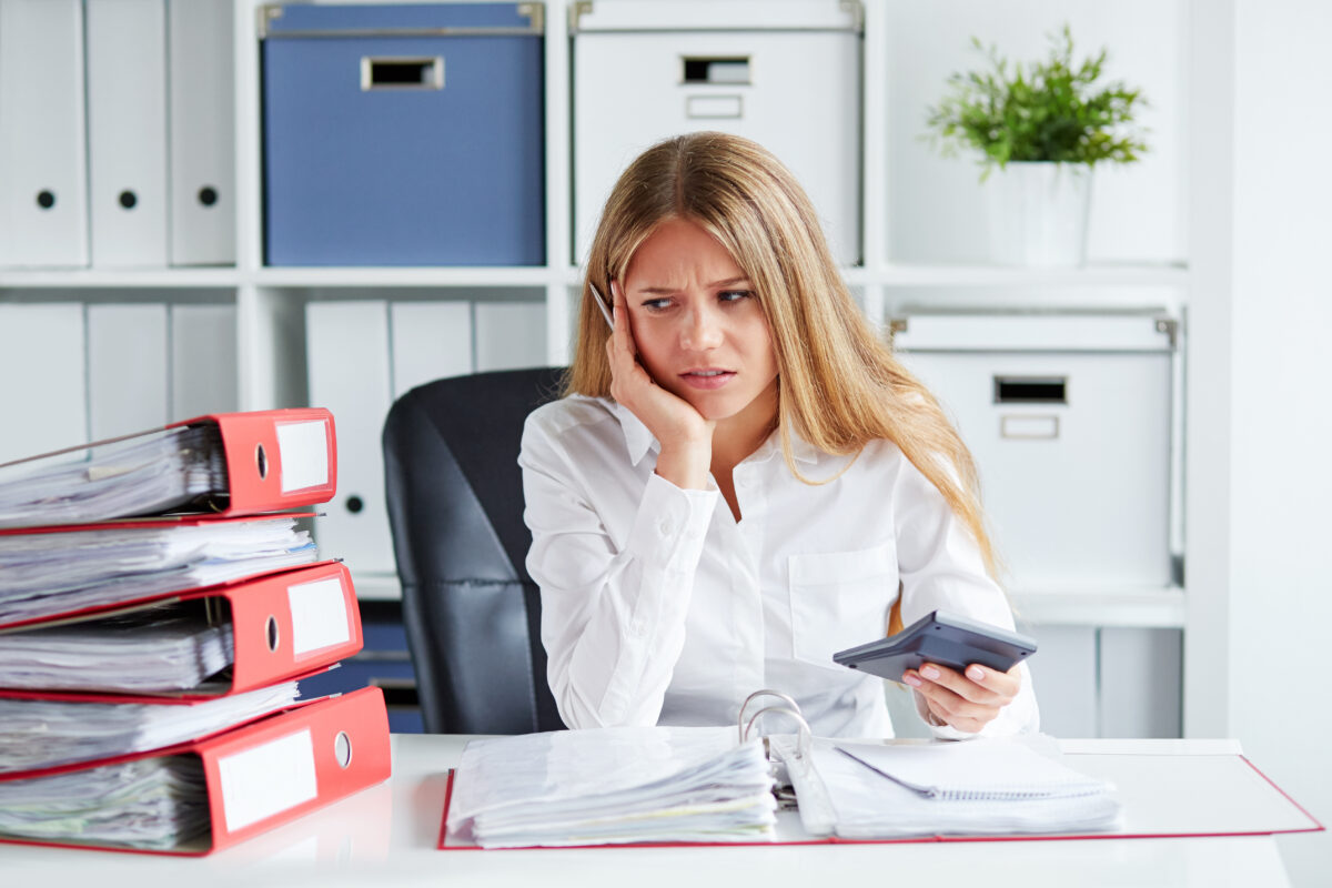 Pensive woman calculates taxes