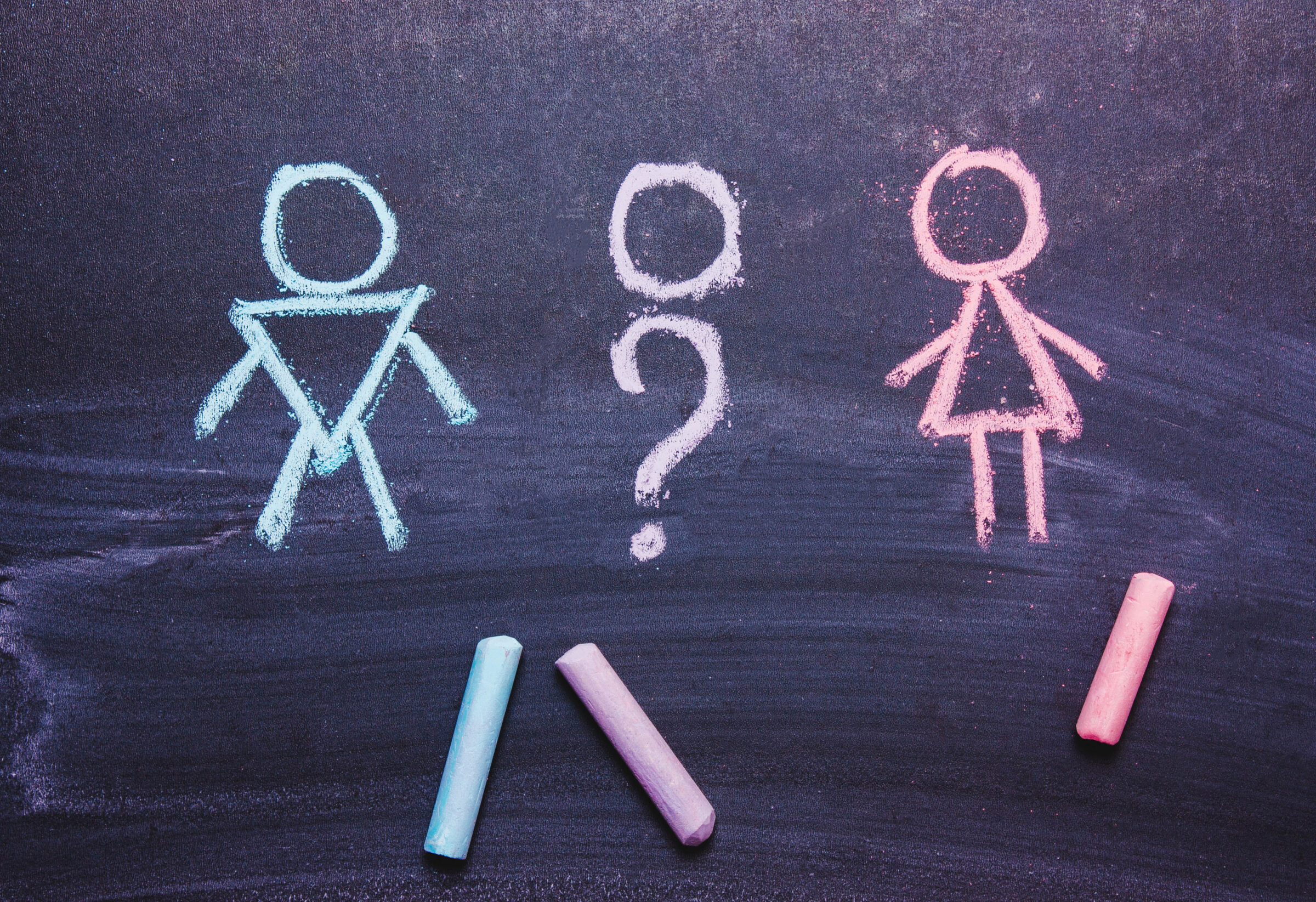 Figures of a man and a woman are drawn chalk on a blackboard. The concept , gender,transgender