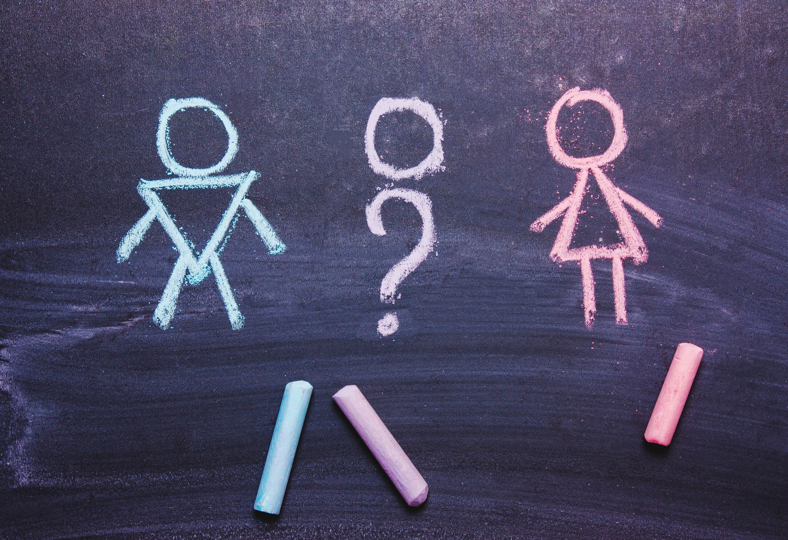 Figures of a man and a woman are drawn chalk on a blackboard. The concept , gender,transgender