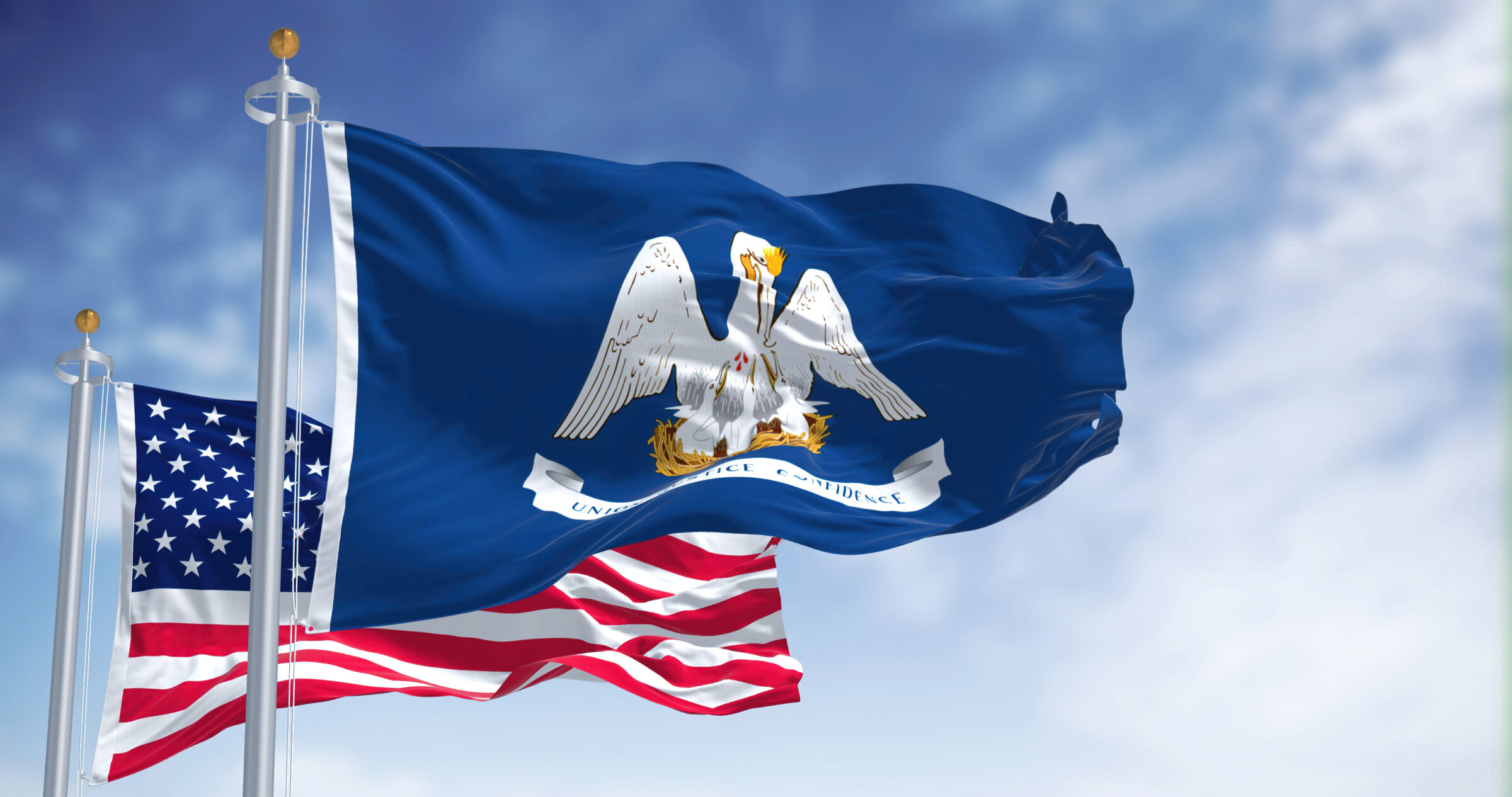 The Louisiana state flag waving along with the national flag of the United States of America
