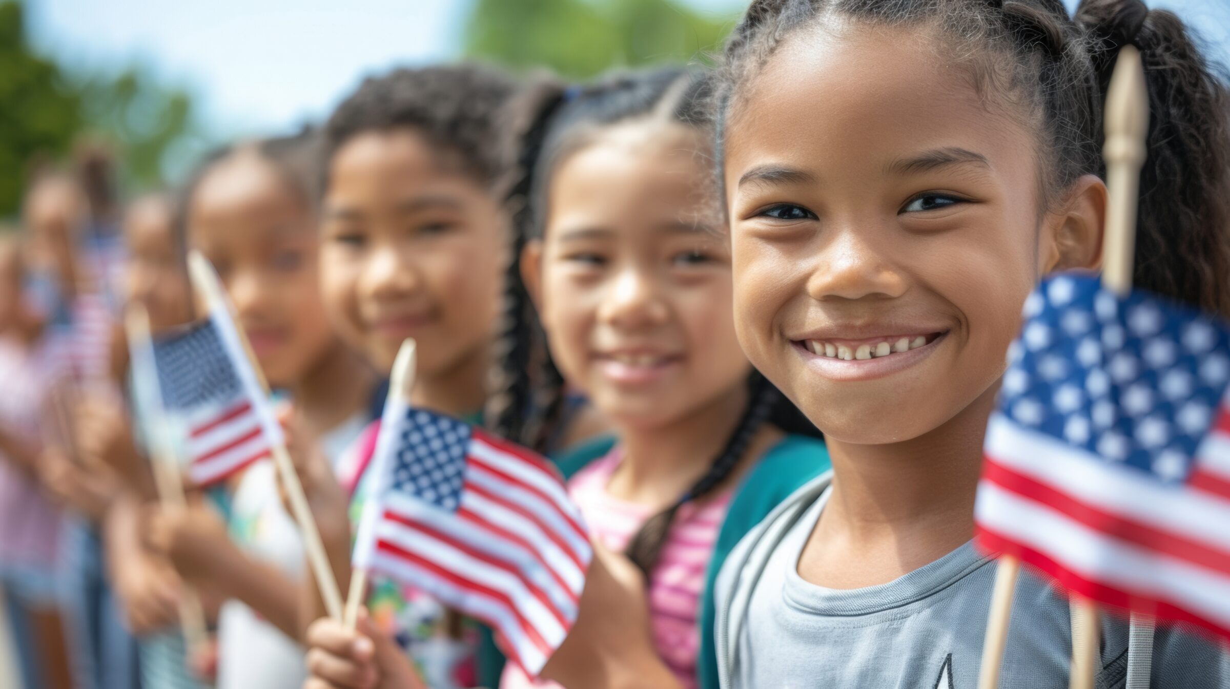 An inspiring image of diverse children holding small American flags